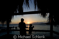 My wife and daughter enjoying the last sunset of our rece... by Michael Schlenk 